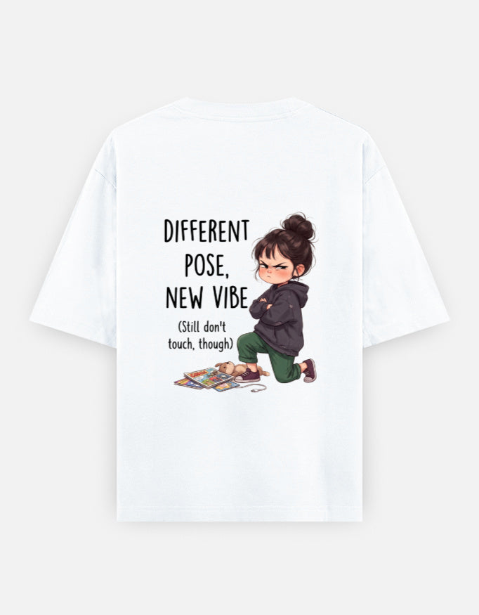 White unisex oversized round-neck T-shirt, back graphic: child and 'Different Pose, New Vibe'.