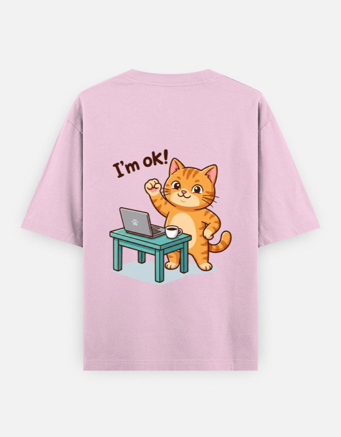 Light baby pink oversized round-neck T-shirt with “I’m ok!” orange cat desk graphic