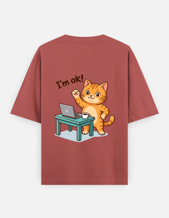 Coral oversized round-neck T-shirt with “I’m ok!” orange cat desk graphic