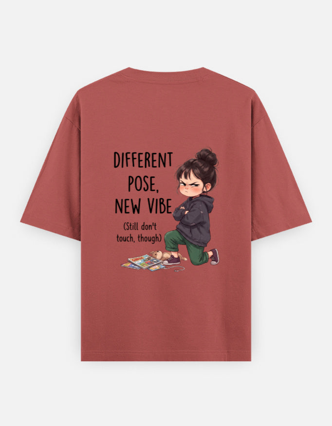 Rust red unisex oversized round-neck T-shirt, back graphic: child and 'Different Pose, New Vibe'.