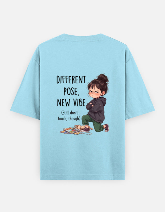 Baby blue unisex oversized round-neck T-shirt, back graphic: child and 'Different Pose, New Vibe'.