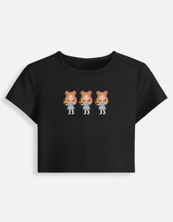 Women’s fitted crop baby tee in black with three cartoon girl graphic on front