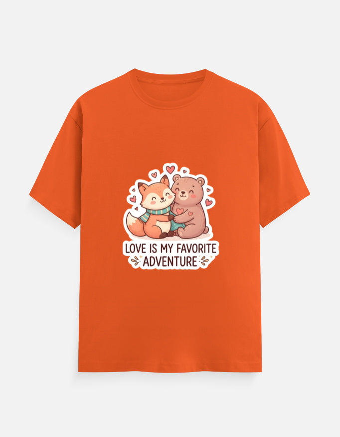 Unisex crew neck T-shirt in orange with cartoon bear graphic, hearts, and 'Love is my favorite adventure'