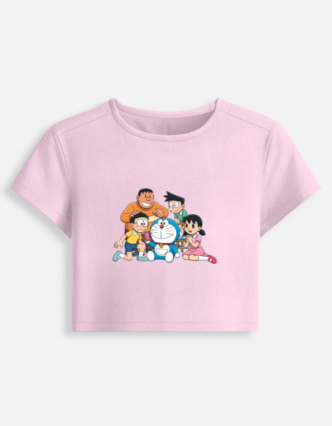 Women’s fitted crop baby graphic tee, light pink; front crewneck with cartoon family print.