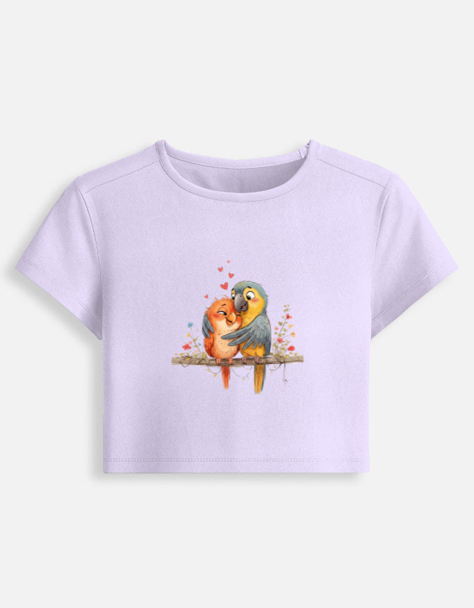 Women’s lavender fitted crop baby tee with colorful bird graphic on the front