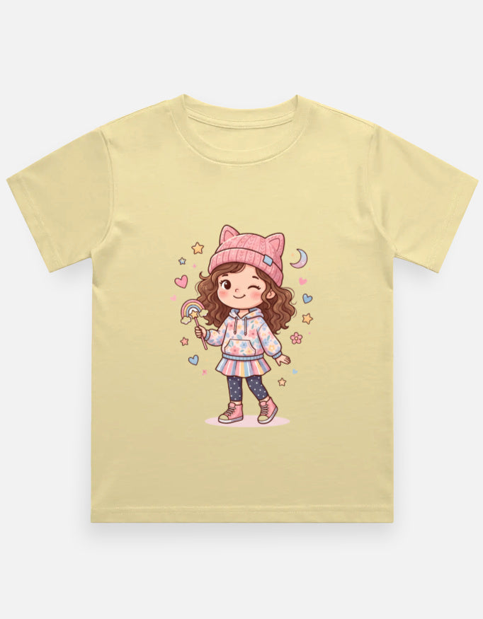 Kids girl’s graphic crew neck T-shirt, pale yellow with cartoon girl illustration on front.