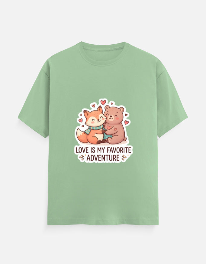 Unisex crew-neck T-shirt in sage green with cartoon bear hearts graphic and "Love is my favorite adventure"