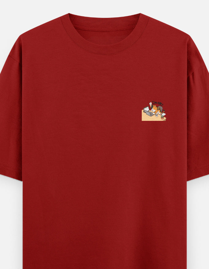 Red unisex oversized round-neck T-shirt with small chest graphic.