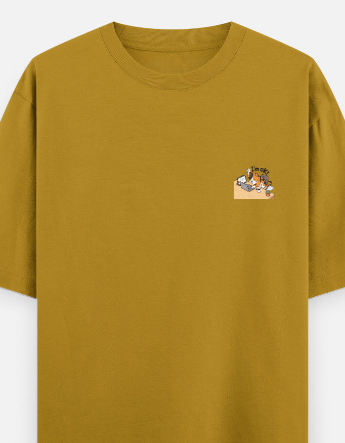 Mustard yellow unisex oversized round-neck T-shirt with small chest graphic.