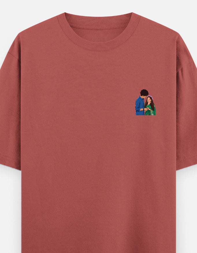 Unisex oversized crewneck T-shirt, coral red, with small couple graphic on chest.